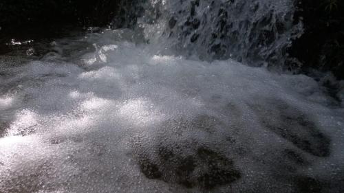 a pile of snow next to a waterfall at Pousada Vertente das Águas in Lumiar