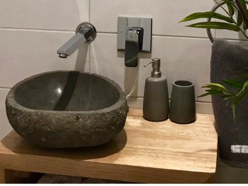 a bathroom with a stone sink and a faucet at Eastern Hill Creswick in Creswick