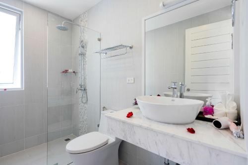 a white bathroom with a sink and a toilet at Sunset Lagoon Villa Rihanna in Bangrak Beach