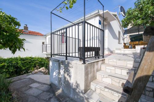 a set of stairs leading to a white house at Strma Apartments in Vis
