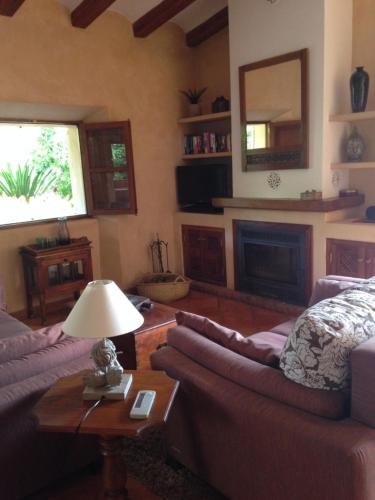 a living room with a couch and a fireplace at Ses llimoneres in Sóller