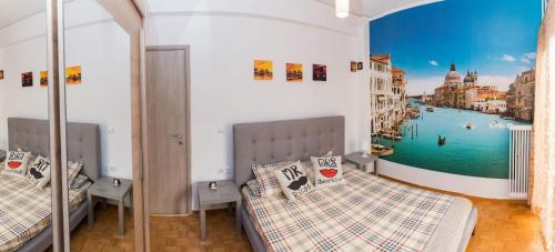 a bedroom with two beds and a mural of a canal at Lianos Apartments Business Class A in Piraeus