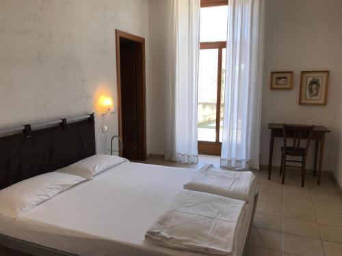 En eller flere senge i et værelse på Appartamenti Gardastivo