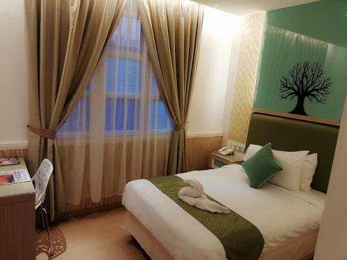 Holiday Place Kuala Lumpur tesisinde bir odada yatak veya yataklar