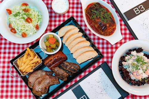 a tray of food with different types of food on a table at Al Ain Palace Hotel Abu Dhabi in Abu Dhabi
