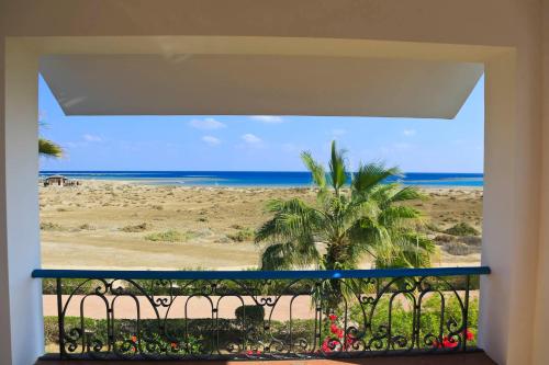 a view from a balcony of a beach with a view of the ocean at Lahami Bay Resort in Abū Ghuşūn