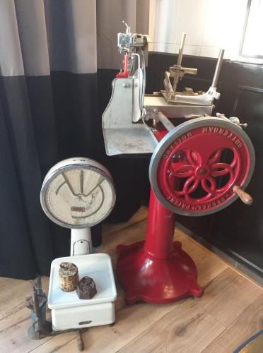 a bathroom with a red toilet and a fan at B&B SJLAOPE BIEJ DE SJLÈCHTER (slapen bij de slager) in Susteren