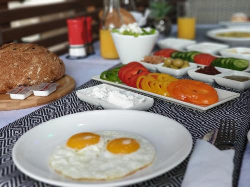 a table topped with plates of food with eggs and vegetables at Spat Beach in Bat Yam