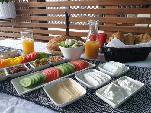 a table with different types of cheese and other foods at Spat Beach in Bat Yam