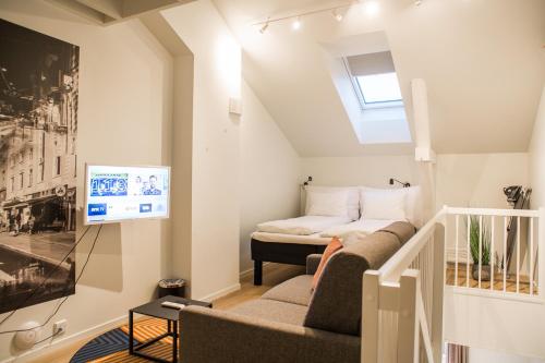 a living room with a bed and a tv at Maya Apartments - Thorvald Meyers gt. 38 in Oslo