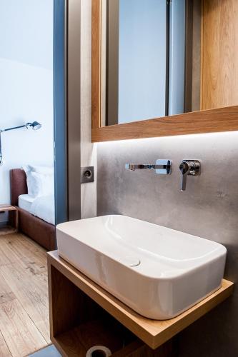 a bathroom with a white sink and a mirror at eswiety10 in Poznań