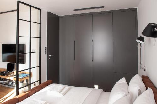 a bedroom with a large white bed and a television at eswiety10 in Poznań
