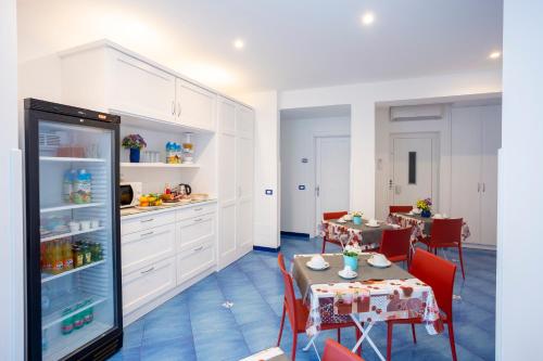 a dining room with two tables and a refrigerator at Casa Vacanze Parco Del Generale in Ischia
