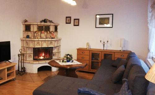 a living room with a couch and a fireplace at Ferienwohnung Gladbeck-Rohde in Gladbeck