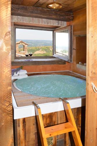a hot tub in a tiny house with a window at Luxury villa Colle dell'Asinello ,proprietari ,Villa In esclusiva near ORVIETO in Guardea