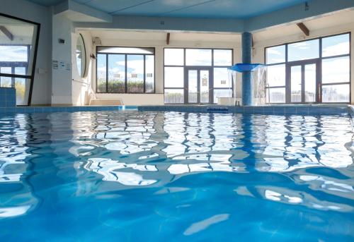 a large swimming pool with blue water at Thalacap Camargue in Saintes-Maries-de-la-Mer