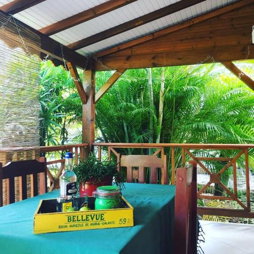 a table with a blue table cloth on a deck at Ti coin paradis in Anse-Bertrand