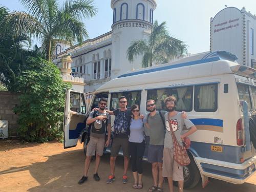 a group of people standing in front of a van at Chola Heritage Resort in Kāraikkudi