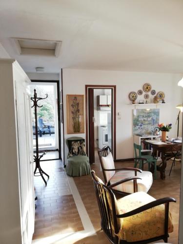 a living room with chairs and a table at Terrazza sul lago in Ameno