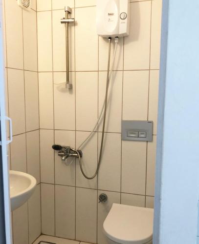 a bathroom with a shower with a toilet and a sink at My Bungalov in Mesudiye