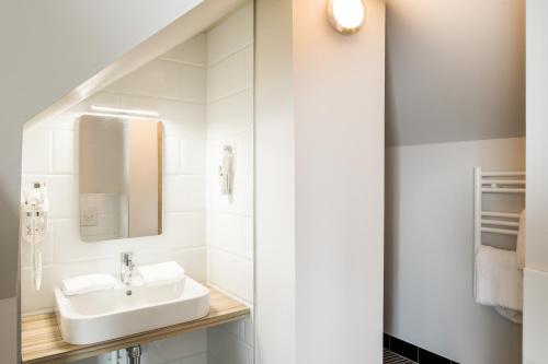 a bathroom with a sink and a mirror at ibis Styles Laval Centre Gare in Laval