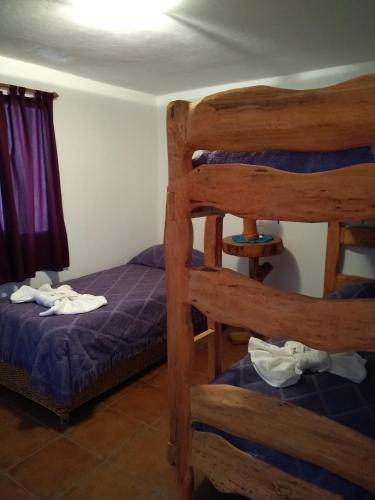 a bedroom with two bunk beds and a window at Laguna Verde Departamentos in Villa Pehuenia