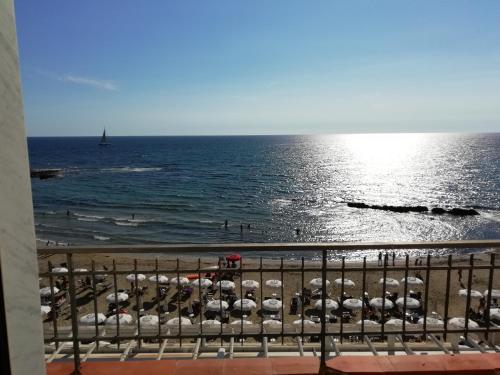 a view of the beach and the ocean from a balcony at Tana delle Sirene Cilento Coast Acciaroli Sea Pollica in Acciaroli