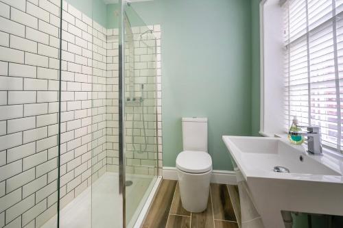 a bathroom with a toilet and a sink and a shower at Walmgate Cottage in York