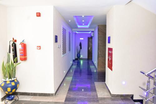 a hallway with purple lights in a building at Qualibest Grand Hotels in Abuja