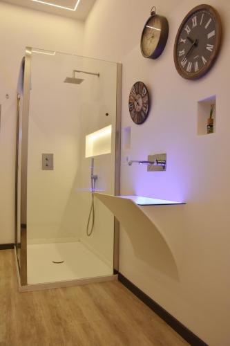 a room with a glass partition with clocks on the wall at La Casa nel Borgo Antico in Melfi