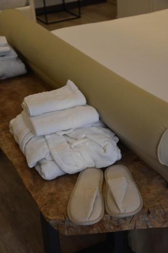 a group of towels and shoes on a table at La Casa nel Borgo Antico in Melfi