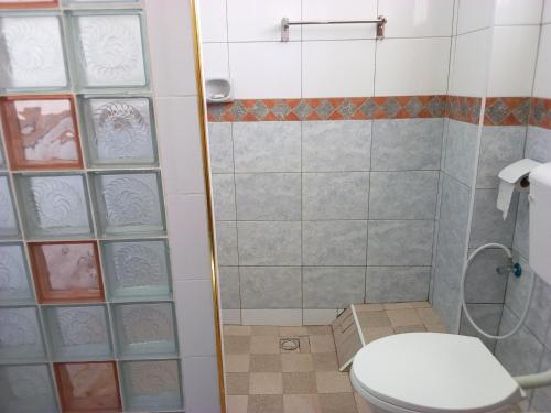 een badkamer met een toilet en een douche bij Premier Guest Residence Hotel in Malindi