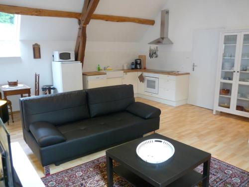 a living room with a couch and a table at Gite Allier in Montaigu-le-Blin