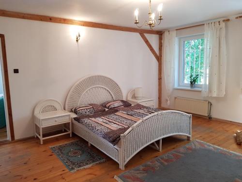 a bedroom with a large white bed and a window at Villa Maximilian in Srokowo