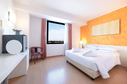 a hotel room with a bed and a window at ibis Styles Roma Vintage in Rome