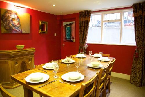 a dining room with a large wooden table with chairs at The Artist House in Brighton & Hove
