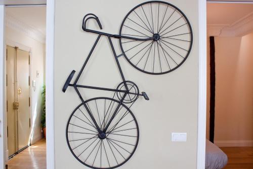 a bike hanging on a wall in a room at Vut carretas 21 in Madrid