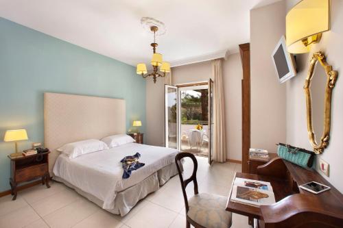 a bedroom with a bed with a dog sitting on it at Hotel Alpha in Sant'Agnello