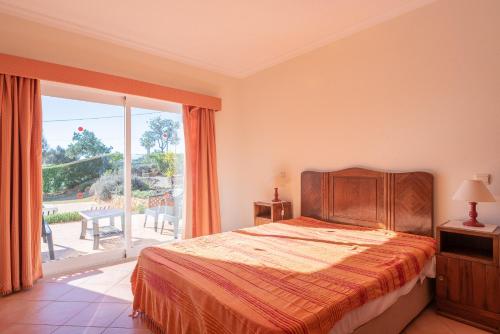 a bedroom with a bed and a large window at Villa Agua by Gabi Miguel in Albufeira