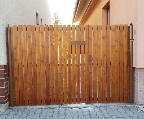 a wooden gate in front of a house at SAUNA Dom in Pezinok