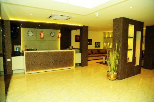 a living room with a kitchen and a lobby at HOTEL KEK GRAND PARK in Chennai