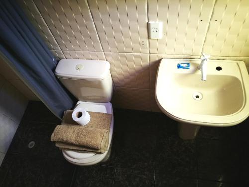 a bathroom with a toilet and a sink at Bolivian Heights Hostel in La Paz