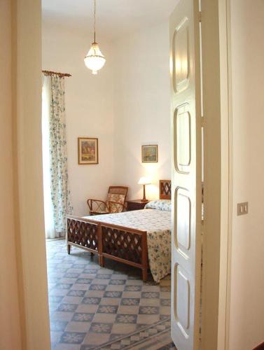 a bedroom with a bed and a chair in a room at Villa Caferì in Porto San Giorgio