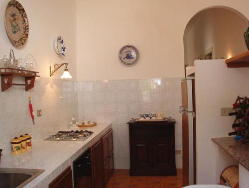 a kitchen with a refrigerator and a counter top at Villa Caferì in Porto San Giorgio