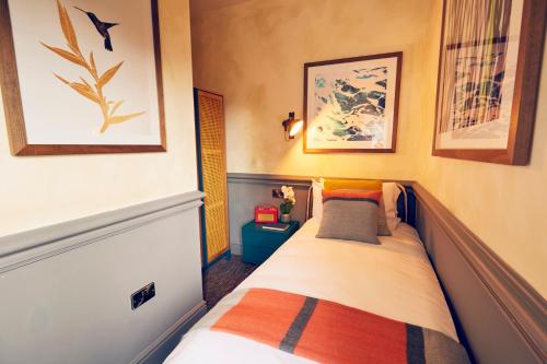 a small bedroom with a bed in a room at Frederick Street Townhouse in Birmingham