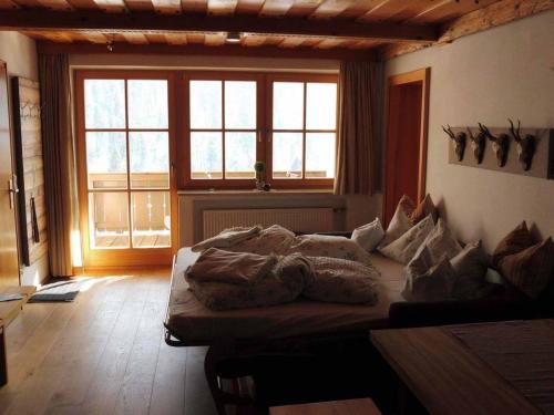 a bedroom with a bed with pillows on it at Haus Eicher in Schneizlreuth