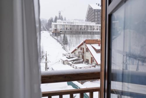 a view from a window of a snow covered mountain at Villa Gor Apartments in Bukovel