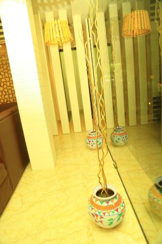three vases sitting on the floor in a room at HOTEL KEK GRAND PARK in Chennai