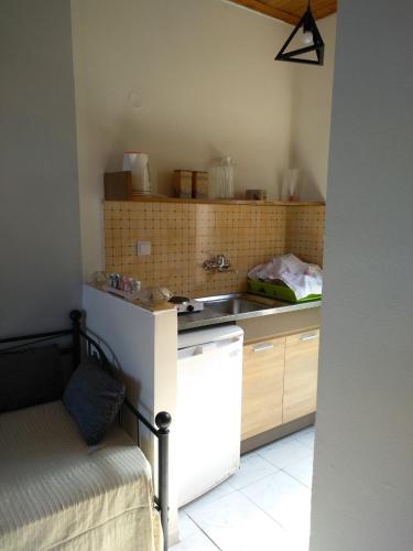 a small kitchen with a sink and a refrigerator at mare di zante "mare di levante" in Alikanas