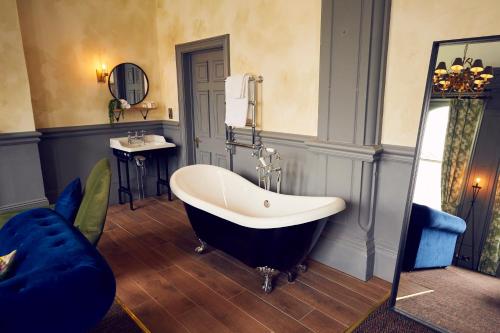 a bath tub sitting next to a window in a room at Frederick Street Townhouse in Birmingham